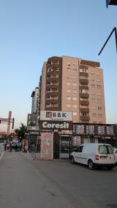a white van parked in front of a building at Cozy apartment in Prishtinë