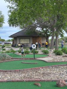 a group of people playing golf on a putting green at Dakota Inn in Huron