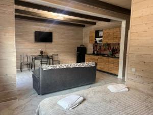a room with a couch and a table with a television at Кольорове життя in Mykulychyn +140 photos
