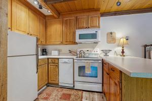 a kitchen with white appliances and wooden cabinets at Sun Valley Atelier Studio - Serenade in Sun Valley