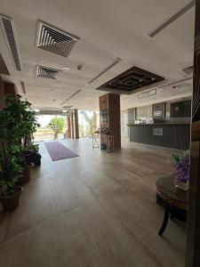 an empty room with a large room with plants at فندق مرسى جيزان الفندقية in Jazan