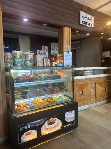 a display case in a bakery with cakes and pastries at فندق مرسى جيزان الفندقية in Jazan