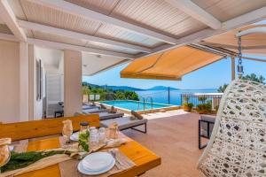 a villa with a view of the pool at Villa St Martin-Reef - Exclusive Seafront Villa with Private Heated Pool in Martinšćica