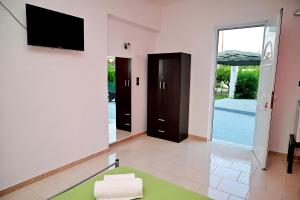 a living room with a flat screen tv on the wall at Karmik Concept Apartments in Afantou