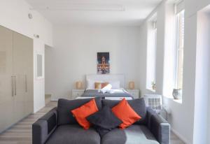 a living room with a couch and a bed at The Clocktower Light and Airy Studio on Bourke St in Melbourne