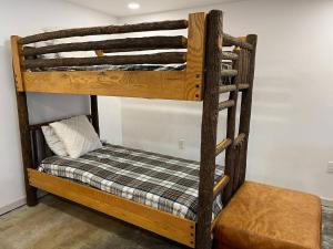 a bunk bed in a room with a seat at Wolf Pond 1 - 3 Miles to Lake Placid NY in Lake Placid