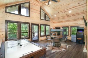 a log cabin kitchen with a table and chairs at Smoky Ridge Hideaway Views Hot Tub Game Room in Sevierville