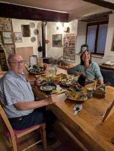 a man and a woman sitting at a table with food at B&B il Tartufo in Sozzi +25 photos