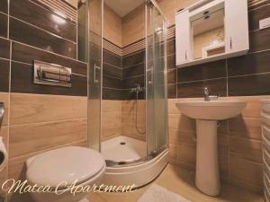 a bathroom with a shower and a toilet and a sink at Matea in Budva