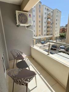 a balcony with two chairs and a air conditioner at Matea in Budva
