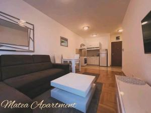 a living room with a couch and a table at Matea in Budva