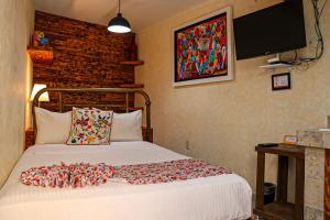 Postel nebo postele na pokoji v ubytování Casa Real Coyoacán