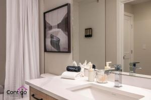 a white bathroom with a sink and a mirror at Rivers Edge, Mtn Views, AC, BBQ, King Bed in Golden +62 photos