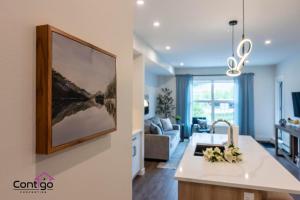 a kitchen and living room with a large painting on the wall at Rivers Edge, Mtn Views, AC, BBQ, King Bed in Golden