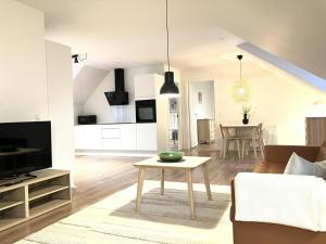 a living room with a couch and a table at Spacious Apartment for 4 in Esbjerg