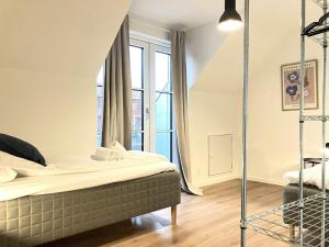 a bedroom with a bed and a large window at Spacious Apartment for 4 in Esbjerg