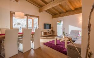 a living room with a dining room table and a couch at Resort Tirol am Wildenbach in Niederau