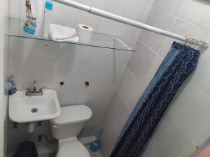 a small bathroom with a toilet and a sink at Affordable, Comfortable, and Convenient – Barcos in Manzanillo