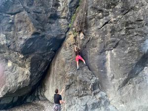 two people on a rope climbing a rock wall at Forest & Sea Campsite in Ts'ikhisdziri +11 photos
