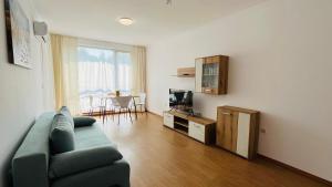 a living room with a couch and a table at ASTORIA II Apartment 54 One Bedroom in Elenite