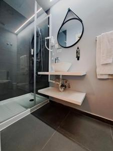a bathroom with a sink and a shower with a mirror at Lisbon City Inn Hotel by City Hotels in Lisbon