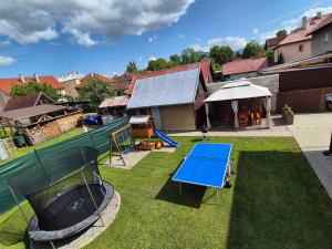 an aerial view of a backyard with a blue table tennis court at Apartmany ROSTER in Liptovský Mikuláš