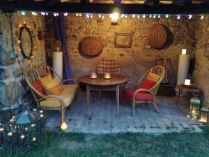 a patio with a table and chairs and lights at La chambre du lac in Meaux-la-Montagne