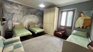 a room with two beds and a painting on the wall at Casa Feliciani - MonferratoHome in Viarigi