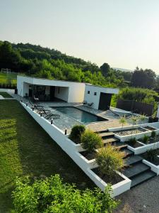 a building with a swimming pool in a yard at Villa Eden Bihać in Bihać