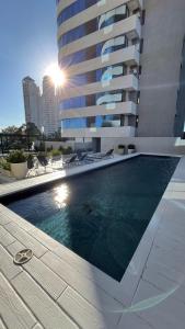 a swimming pool in front of a tall building at Torres Brickell Six in Tigre