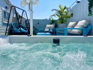 a pool of water in a backyard with a bench at Cancun in Netanya