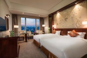 Postel nebo postele na pokoji v ubytování Overseas Chinese Hotel Wenzhou