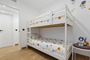 a white bunk bed in a childs bedroom at Urban Oasis in Fuengirola +19 photos