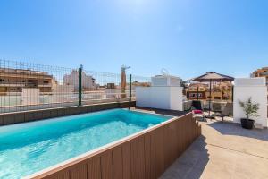 a swimming pool on the roof of a building at Urban Oasis in Fuengirola