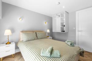 a bedroom with a bed with towels on it at The Mail Rooms Limavady - Boutique Stays in Limavady