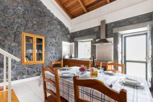 a kitchen and dining room with a table and chairs at Casa da Torre in São João