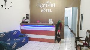 a lobby of a hotel with a counter with colorful stripes at Nafisha Hotel Bukittinggi in Bukittinggi