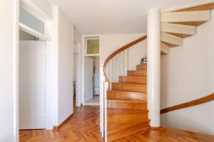 a staircase in a home with white walls and wood floors at Holiday Home Mareta in Dubrovnik