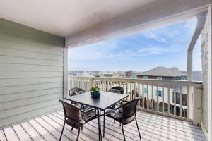 a patio with a table and chairs on a balcony at Lagoon Landing #302 in Gulf Shores
