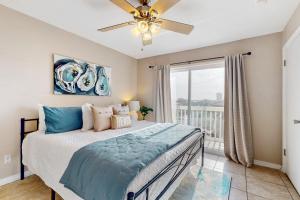 a bedroom with a bed and a ceiling fan at Lagoon Landing #302 in Gulf Shores +15 photos