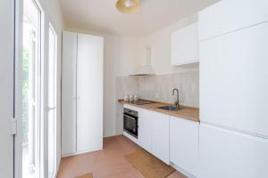 a kitchen with white cabinets and a sink at Holiday Home Mareta in Dubrovnik +29 photos
