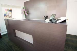 a reception desk in an office with a book at A Line Motel in Griffith