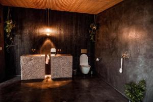 a bathroom with a sink and a toilet in it at Moderne Sea View Villa mit Pool in Santo Isidoro