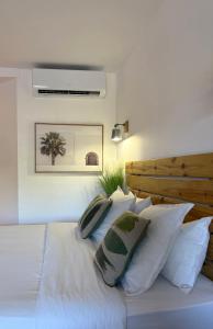 a bedroom with a white bed with white pillows at Happy studio Orient bay Palm court Residence in Orient Bay +10 photos