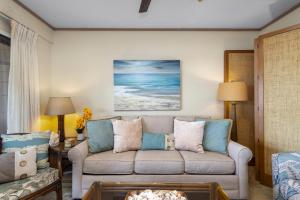 a living room with a couch and a table at Direct Oceanfront Beach Pohailani Studio - New in Kahana