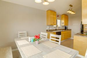 a kitchen with a dining room table with chairs and a counter at Beach Access and Hot Tub Coastal Gem in Manchester in Manchester