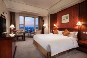 Postel nebo postele na pokoji v ubytování Overseas Chinese Hotel Wenzhou