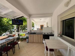 a kitchen and dining room with a table and a counter at Vila Bella in Durrës