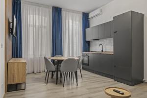 a kitchen and dining room with a table and chairs at Interbelic Villa close to Old Town in Bucharest