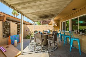 a patio with a table and chairs under awning at Scottsdale Getaway with Hot Tub Games and Office in Scottsdale